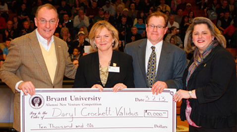 (L-R) President Ronald K. Machtley, Daryl (David) Crockett '82, her husband Dean, and  National Alumni Council President Jennifer Parkhurst '97, '06 MBA.